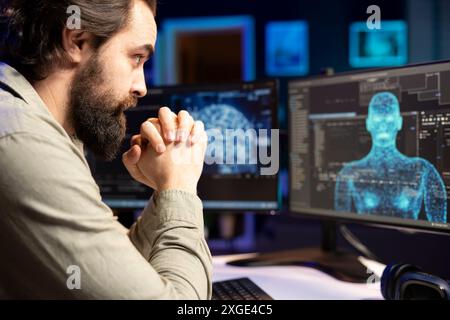 Software developer unable to believe eyes after seeing AI gaining humanoid form and consciousness. Computer scientist surprised by artificial intelligence materializing on screen unprompted Stock Photo