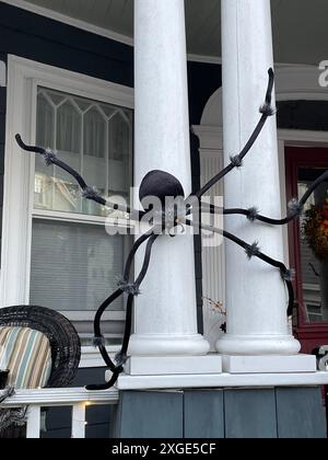 A large spider appears to crawl on the columns of a historic home near Halloween in Salem Massachusetts Stock Photo