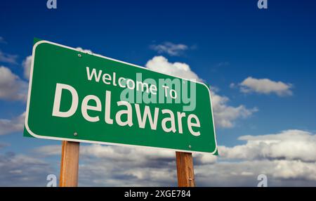 Welcome To Delaware Green Road Sign Over Blue Sky with Some Clouds. Stock Photo