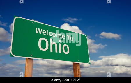 Welcome To Ohio Green Road Sign Over Blue Sky with Some Clouds. Stock Photo