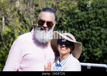 Smiling senior couple wearing sunglasses and hats, enjoying outdoor time together Stock Photo