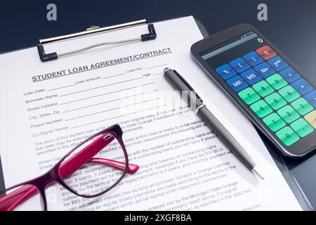 Blank Student Loan Application, calculator, pen and eyeglasses on table. Education cost concept Stock Photo