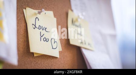 Close up of pinned note ?Love you? on cork board Stock Photo