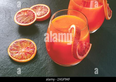 Orange cocktail, toned image with Sicilian oranges on a black background Stock Photo