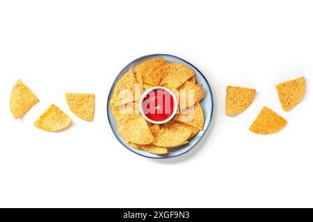 Nachos, Mexican tortilla chips, shot from the top on a white background with a red sauce Stock Photo