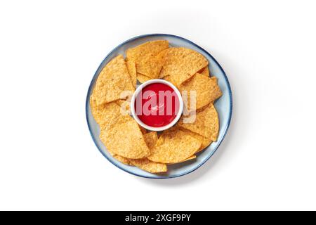 Nacho chips on a plate with a tomato salsa, shot from the top on a white background Stock Photo