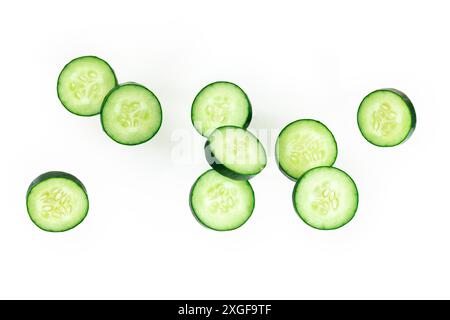 Cucumber slices, levitating on a white background, healthy food concept Stock Photo