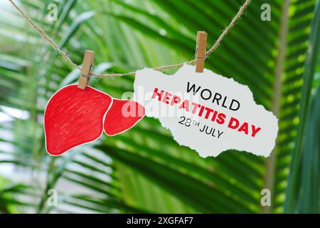 World Hepatitis Day on July 28 on torn paper with bokeh nature background Stock Photo