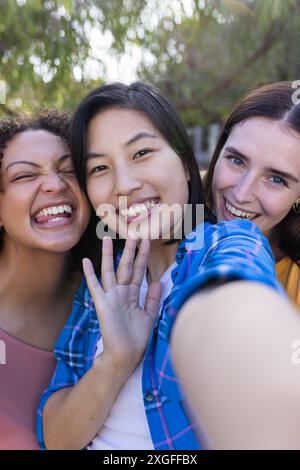 Smiling friends taking selfie outdoors, enjoying time together and having fun Stock Photo