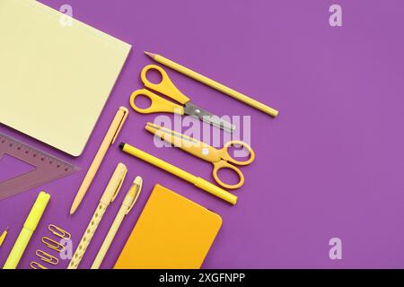 Different stationery on purple background Stock Photo