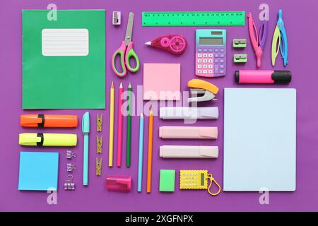 Different stationery on purple background Stock Photo
