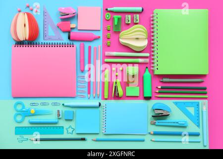 Composition with notebooks and stationery on color background Stock Photo