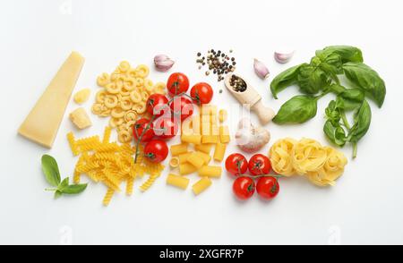 Different types of pasta, spices and products on white background, top view Stock Photo