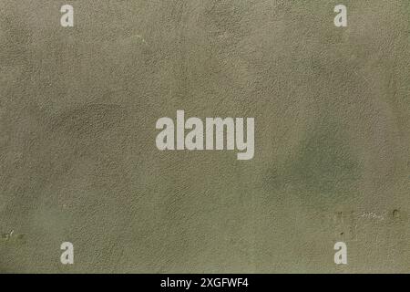 Background texture of wall with old worn pale green stucco or cement Stock Photo