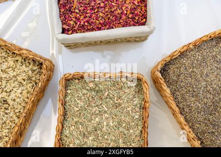 boxes with different types of tea leaves herbal and floral on white background. Tea collection of four different types of tea leafs. Horizontal. Top v Stock Photo