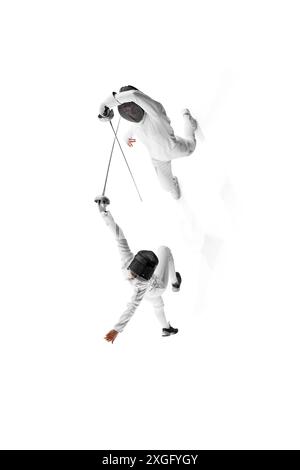 Poster. View from above of two female athletes, fencers work on their footwork and blade technique against white studio background. Stock Photo