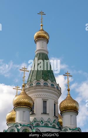 The golden gilded domes of Church of St Nicholas the Miracle-Maker in Sofia Bulgaria against blue sky. Stock Photo