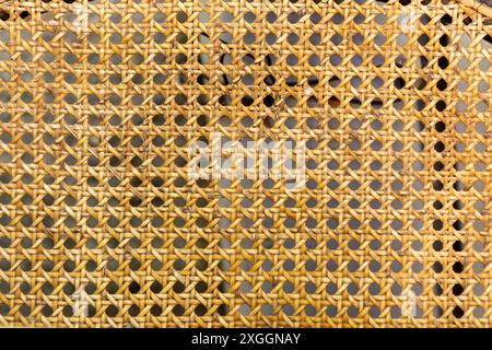Close up texture of handwoven rattan in hexagonal pattern, vintage furniture detail Stock Photo