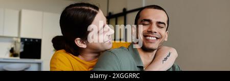 A young gay couple enjoys a quiet moment together in their modern apartment. Stock Photo