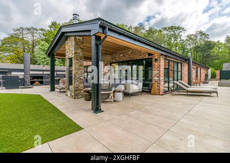 Large executive house with pool house, gym and outdoor kitchen in a leafy suburb of England Stock Photo