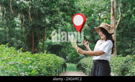 Tourists wearing white tops wearing brim hats using a navigation app on their mobile phones. Beautiful woman uses mobile application to navigate in Th Stock Photo