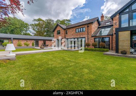 Large executive house with pool house, gym and outdoor kitchen in a leafy suburb of England Stock Photo