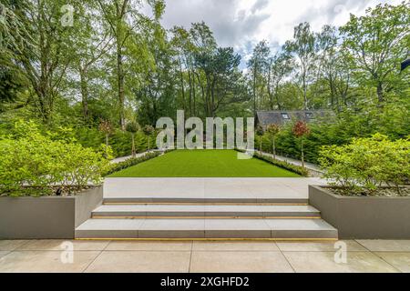 Large executive house with pool house, gym and outdoor kitchen in a leafy suburb of England Stock Photo