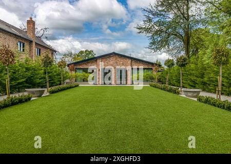 Large executive house with pool house, gym and outdoor kitchen in a leafy suburb of England Stock Photo