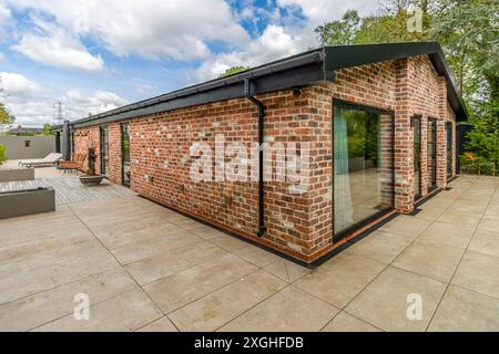 Large executive house with pool house, gym and outdoor kitchen in a leafy suburb of England Stock Photo