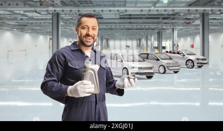 Car mechanic opening engine oil bottle in a garage Stock Photo
