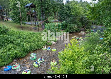 Tubers enjoying a summer day floating down the Chattahoochee River from Cool River Tubing And Adventures in Helen, Georgia. (USA) Stock Photo