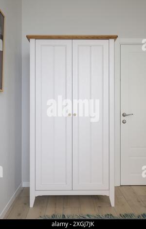 Free standing white wardrobe in the room interior Stock Photo