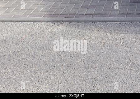 blocks on the pavement with an asphalt street surface Stock Photo