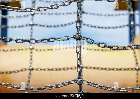 a metal chain connected by a screw and nut Stock Photo