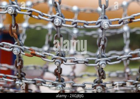 a metal chain connected by a screw and nut Stock Photo