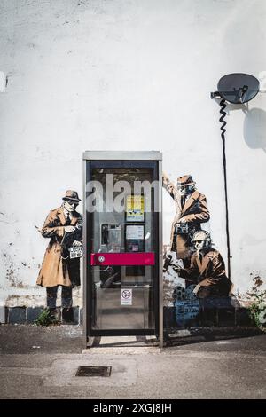 Banksy Spy Booth Wall Art Around Phone Box In Cheltenham Stock Photo