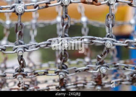 a metal chain connected by a screw and nut Stock Photo