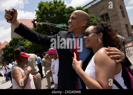 Sen. Cory Booker, D-N.J., center, speaks with visitors in Hart Senate