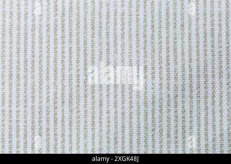 A white and green vertical striped fabric with a pattern of squares. The fabric is very plain and simple. Texture. Stock Photo