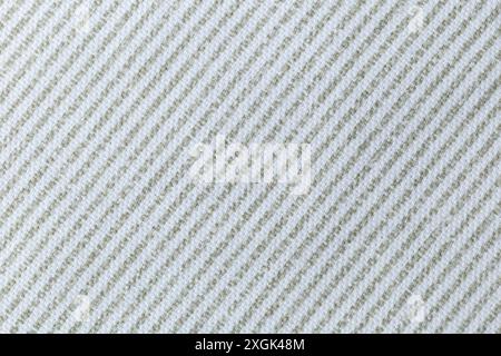 A white and green diagonal striped fabric with a pattern of squares. The fabric is very plain and simple. Texture. Stock Photo