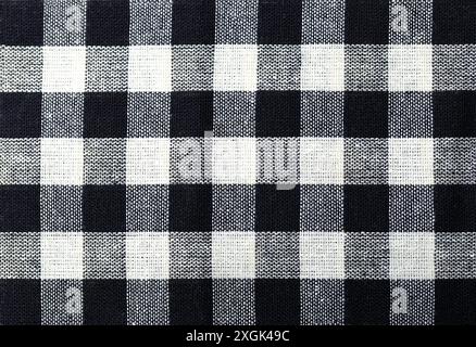 Black and white geometric check fabric sample. The fabric is made of a woven material. Stock Photo