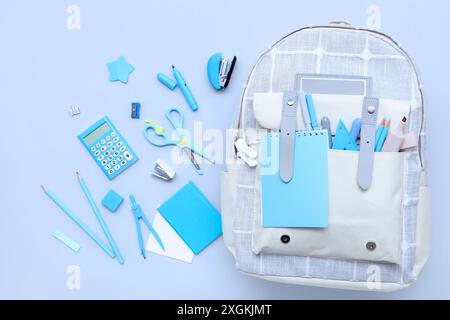 Composition with different stationery and stylish school backpack on color background Stock Photo