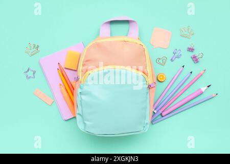 Composition with different stationery and stylish school backpack on color background Stock Photo