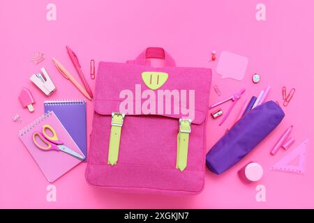 Composition with stylish school backpack and different stationery on pink background Stock Photo