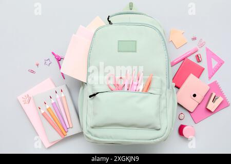 Composition with different stationery and stylish school backpack on grey background Stock Photo