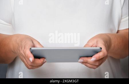 Senior woman using tablet close-up Stock Photo