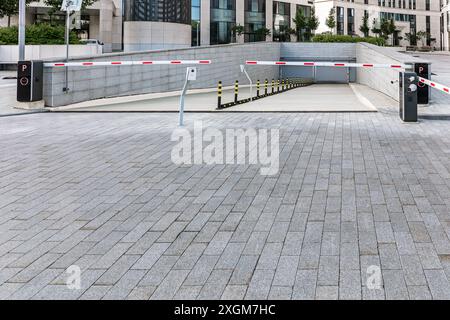 underground garage parking entrance with closed automatic boom barrier. Stock Photo