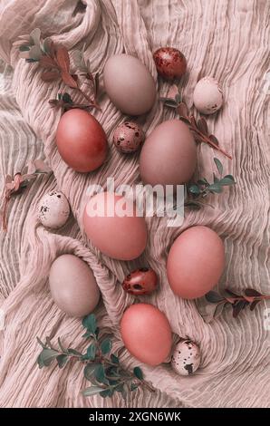 Easter eggs, coral tone, on beige fabric, top view, vertical, no people, Easter card Stock Photo