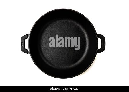 Cast iron roaster, with two handles, for cooking, without lid, on a white background, top view, horizontal Stock Photo