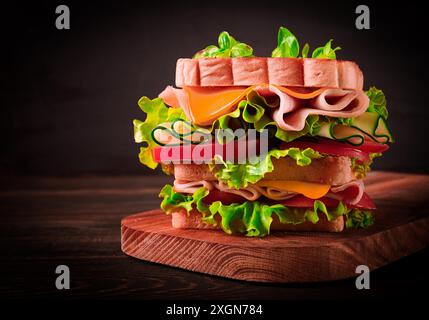 Club sandwich, on a wooden table, rustic style, close-up, no people, homemade Stock Photo